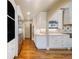 Bright kitchen featuring stainless steel appliances, white cabinets, hardwood floors and a large built-in refrigerator at 850 E Radcliff Ave, Cherry Hills Village, CO 80113