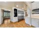 Open concept kitchen with white cabinets, wood floors, stainless steel appliances, and ample counter space at 850 E Radcliff Ave, Cherry Hills Village, CO 80113