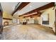 Spacious living area featuring a stone fireplace, wood beams, and a convenient wet bar at 850 E Radcliff Ave, Cherry Hills Village, CO 80113