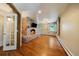 Spacious living room boasts brick fireplace, hardwood floors, large windows and French doors at 850 E Radcliff Ave, Cherry Hills Village, CO 80113