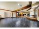 Large living area with tile floors, wood beams, and fireplace at 850 E Radcliff Ave, Cherry Hills Village, CO 80113