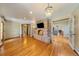 Inviting living room with hardwood floors, brick fireplace, and elegant lighting fixture at 850 E Radcliff Ave, Cherry Hills Village, CO 80113