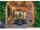 Cozy outdoor patio with brick accents, dining area, built-in grill and decorative string lights at 850 E Radcliff Ave, Cherry Hills Village, CO 80113