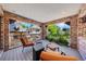 Inviting brick patio featuring comfortable seating, iron railings, and views of the surrounding greenery at 850 E Radcliff Ave, Cherry Hills Village, CO 80113