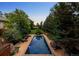 Beautiful pool area surrounded by mature trees and landscaping, perfect for outdoor relaxation at 850 E Radcliff Ave, Cherry Hills Village, CO 80113