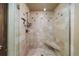 Walk-in shower featuring neutral tile, hand shower and built-in bench at 850 E Radcliff Ave, Cherry Hills Village, CO 80113