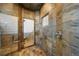 Modern shower features textured tile, glass door, and sleek fixtures for a spa-like experience at 850 E Radcliff Ave, Cherry Hills Village, CO 80113
