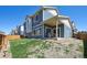 Well-maintained backyard with a covered patio, grass area, and partial fence, perfect for outdoor living at 10207 Xanadu St, Commerce City, CO 80022