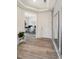 Entryway with hardwood floors, view of a study through an archway, and a white entry door at 10207 Xanadu St, Commerce City, CO 80022