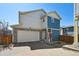 Beautiful two story home with mixed stone and siding, attached garage, and well maintained front yard at 10207 Xanadu St, Commerce City, CO 80022