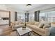 Bright living room featuring large windows, hardwood floors, neutral furniture and modern decor at 10207 Xanadu St, Commerce City, CO 80022