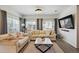 Bright living room featuring large windows, hardwood floors, neutral furniture, and modern decor at 10207 Xanadu St, Commerce City, CO 80022