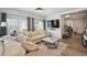 Open living space with wood floors, a TV, comfortable seating and a staircase leading upstairs at 10207 Xanadu St, Commerce City, CO 80022