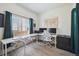 Bright home office featuring a large window, two workstations, and elegant décor at 10207 Xanadu St, Commerce City, CO 80022