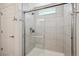 This is a walk-in shower with subway tile and seamless glass door at 10207 Xanadu St, Commerce City, CO 80022