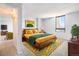 Cozy bedroom with a large window providing natural light and vibrant decor at 1020 15Th St # 7A, Denver, CO 80202