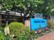 Exterior view of building sign amidst green landscaping with mature trees at 1020 15Th St # 7A, Denver, CO 80202