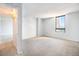 Open room with an attached room visible via the doorway and natural light at 1020 15Th St # 7A, Denver, CO 80202