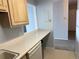 Compact kitchen layout featuring essential appliances, neutral countertops, and doorway to adjoining rooms at 1020 15Th St # 7A, Denver, CO 80202