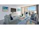 Bright living room featuring stylish furniture, a flat-screen TV, and a balcony with city views at 1020 15Th St # 7A, Denver, CO 80202