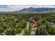 Stunning aerial view of lush neighborhood with majestic mountain backdrop and tree-lined streets at 3545 Cloverleaf Dr, Boulder, CO 80304