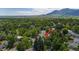 Scenic aerial shot showcasing a verdant neighborhood nestled amidst picturesque mountain views at 3545 Cloverleaf Dr, Boulder, CO 80304