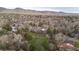 Panoramic aerial shot capturing a neighborhood nestled against a backdrop of rolling hills and open spaces at 3545 Cloverleaf Dr, Boulder, CO 80304