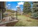 Spacious backyard featuring a covered patio, lush lawn, and mature trees at 3545 Cloverleaf Dr, Boulder, CO 80304