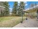 Serene backyard with a covered patio, a well-manicured lawn, and mature trees at 3545 Cloverleaf Dr, Boulder, CO 80304