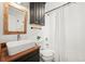 Bathroom features dark vanity, bright white tile, and walk-in shower at 3545 Cloverleaf Dr, Boulder, CO 80304