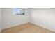 Empty bedroom featuring light hardwood floors and a bright window at 3545 Cloverleaf Dr, Boulder, CO 80304