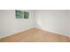 Bright, empty bedroom featuring light hardwood floors and a sunlit window at 3545 Cloverleaf Dr, Boulder, CO 80304