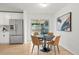 Dining area featuring a table with modern chairs near the stainless steel refrigerator at 3545 Cloverleaf Dr, Boulder, CO 80304