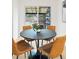 Close-up of dining area with modern chairs around a round table, backyard access at 3545 Cloverleaf Dr, Boulder, CO 80304