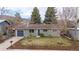 Well-maintained single-Gathering home featuring a manicured lawn, mature trees, and a charming blue accent garage at 3545 Cloverleaf Dr, Boulder, CO 80304