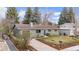 The exterior of this charming single-Gathering home features lush landscaping and mature evergreen trees at 3545 Cloverleaf Dr, Boulder, CO 80304