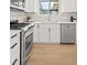 Bright kitchen features white cabinets, stainless steel appliances, and a sunlit window at 3545 Cloverleaf Dr, Boulder, CO 80304
