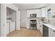 Modern kitchen featuring stainless steel appliances, light wood flooring, and washer-dryer at 3545 Cloverleaf Dr, Boulder, CO 80304