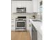 Bright kitchen features white cabinets, stainless steel appliances, and light hardwood floors at 3545 Cloverleaf Dr, Boulder, CO 80304