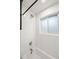 Bright white tiled shower with sleek fixtures and a glass block window at 3545 Cloverleaf Dr, Boulder, CO 80304