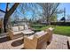 Inviting outdoor patio area featuring comfortable wicker furniture, ideal for relaxation and social gatherings at 4920 Clay St, Denver, CO 80221