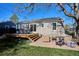 Expansive backyard with a deck, brick patio, and lush lawn, perfect for outdoor living and recreation at 4920 Clay St, Denver, CO 80221
