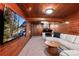 Basement Gathering room features wood paneling, plush carpet, and a media center for cozy entertainment at 4920 Clay St, Denver, CO 80221
