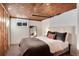 Finished basement bedroom with wood paneled ceiling at 4920 Clay St, Denver, CO 80221