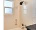 Bathroom with shower-tub, new shower head, and fixtures at 4920 Clay St, Denver, CO 80221