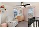 Bedroom with stylish crib, dresser, rocking chair, and natural light at 4920 Clay St, Denver, CO 80221
