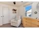 Comfortable Bedroom featuring a rocker, changing table, and bright natural light at 4920 Clay St, Denver, CO 80221