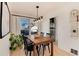 Bright dining room with natural light, stylish furniture, and sliding door access to backyard at 4920 Clay St, Denver, CO 80221