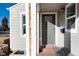 Stylish front entrance with a gray front door, modern lighting, and a convenient bench for visitors at 4920 Clay St, Denver, CO 80221