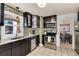 Well-lit kitchen with stainless steel appliances, mosaic backsplash, and modern finishes at 4920 Clay St, Denver, CO 80221